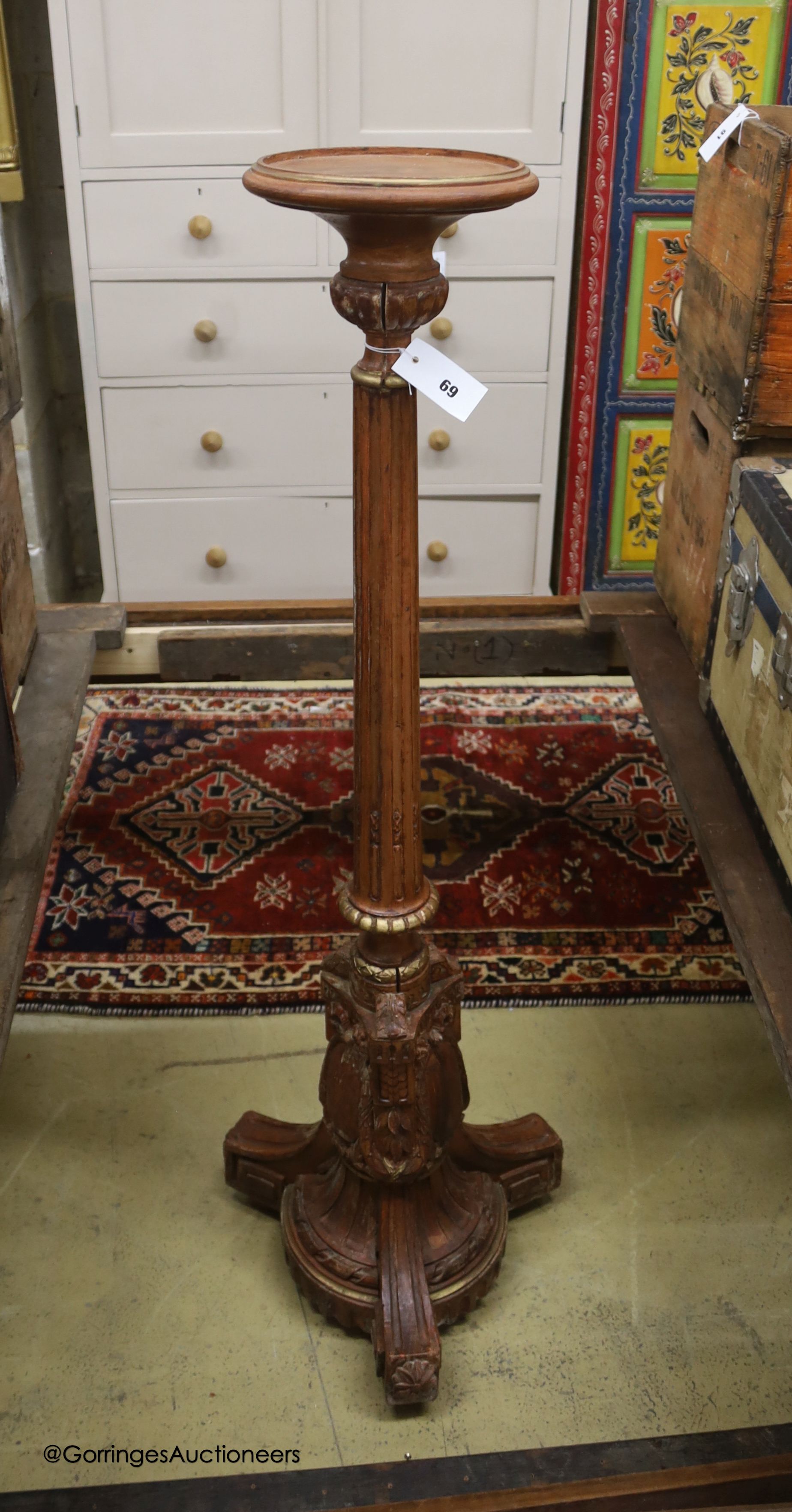 A carved wood parcel gilt torchere, height 125cm